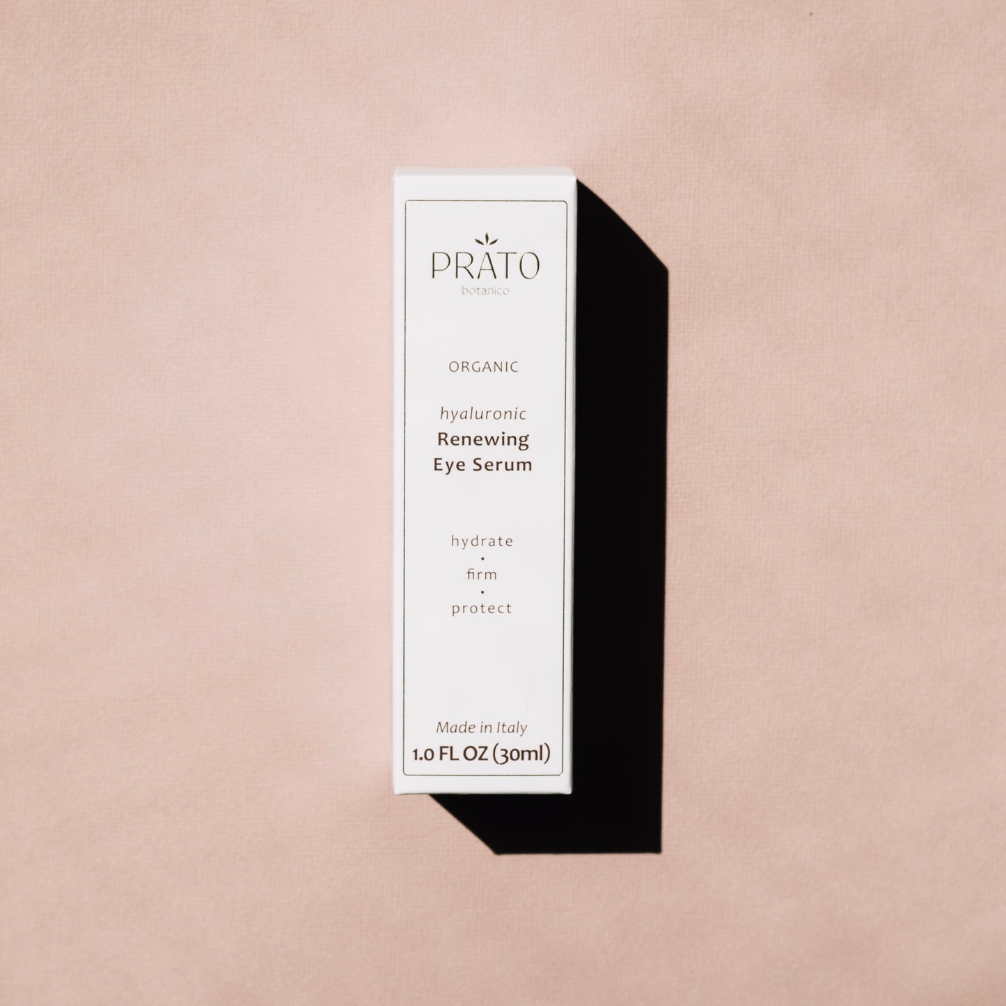 Prato Botanico Renewing Eye Serum on pink background with shadow