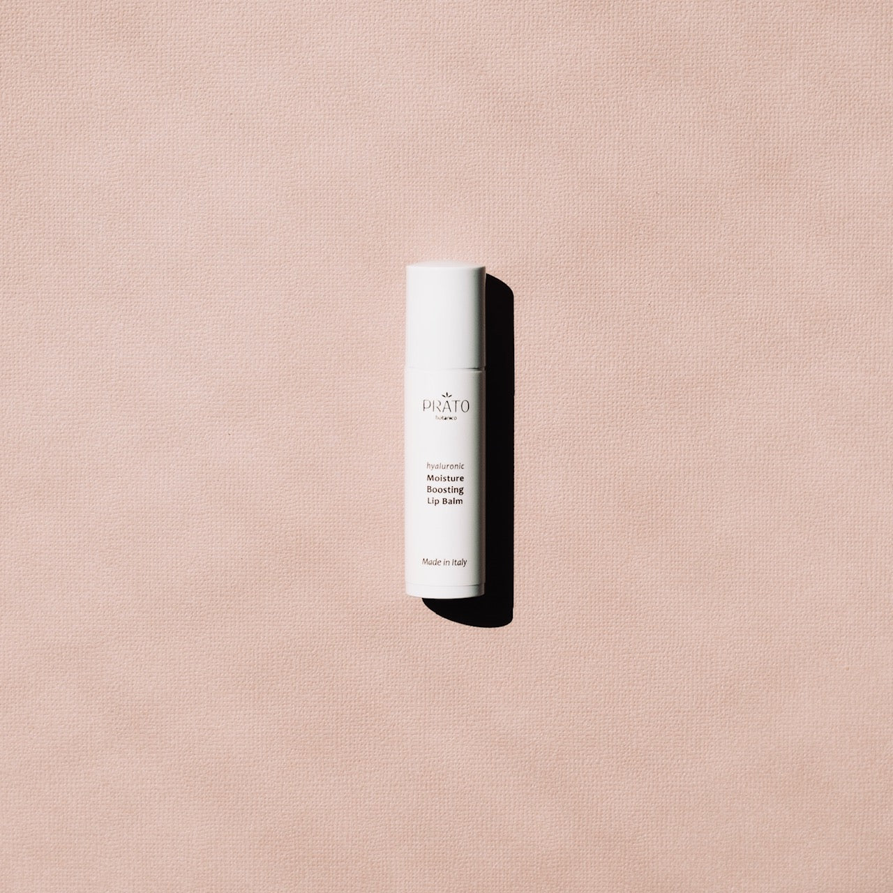 Prato Botanico Organic Hyaluronic Acid Moisture Boosting Lip Balm on pink background