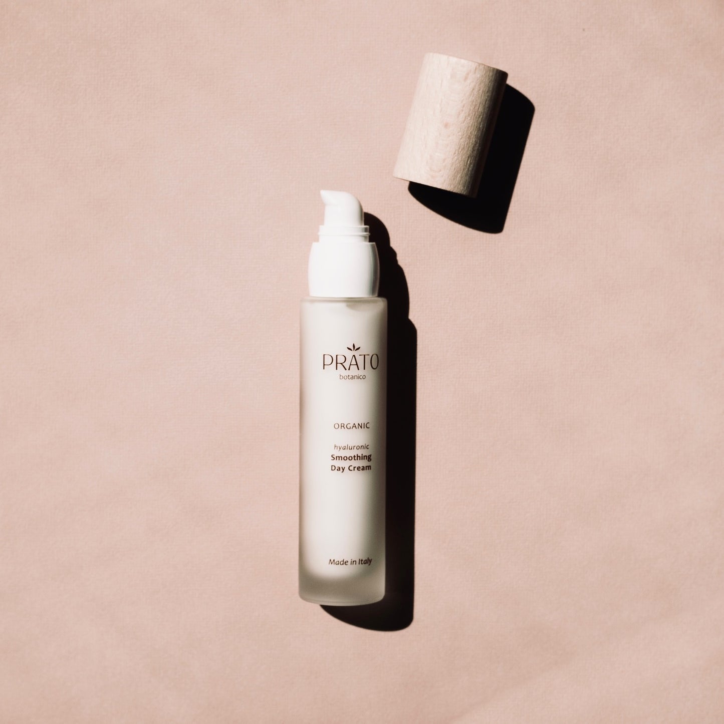 Organic Hyaluronic acid Prato Botanico Smoothing Day Cream with sustainable beechwood lid on pink background